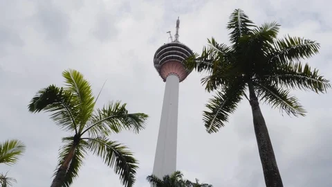 Tall broadcast tower with palm trees during foggy day, Kuala Lumpur, Malaysia Stock Footage 146560008