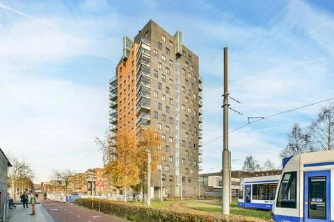 A tall building with a bus in front of it Stock Photos