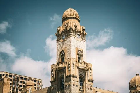 A tall building with a clock on the side Stock Photos
