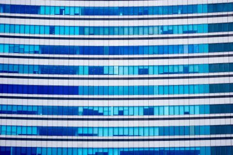 Tall building facade windows front view. Green windows facade of a tall build Stock Photos