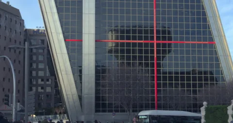 A tall building with a red cross on it 스톡 동영상 327320334