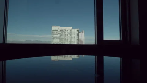 Tall Building Reflection with Mountains Stock Footage 281381224