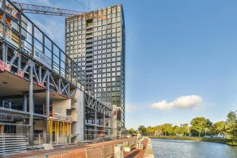 A tall building with a river in front of it Stock Photos