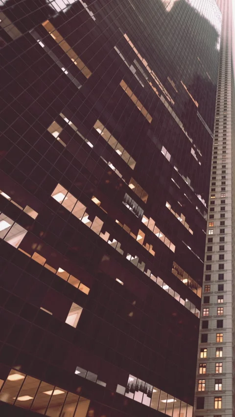 Tall building structure with windows showing light at evening time Stock Footage 342189759