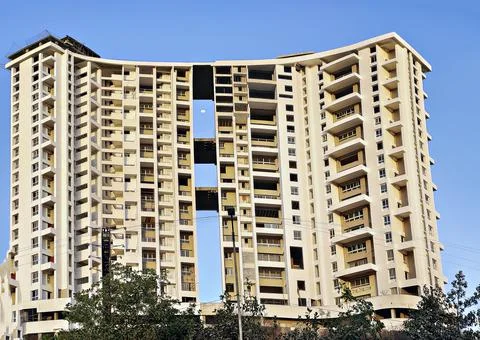 Tall building under construction on a background of blue sky. Stock Photos
