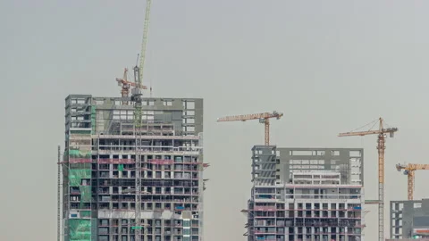 Tall buildings under construction and cranes timelapse Stock Footage 197117587