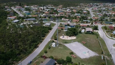 Tall Cell Tower Standing Above Pioneers Loop Residential Area, Freeport Aerial Stock Footage 90105517