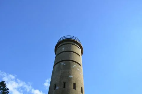 Tall cement tower structure with blue sky Stock Photos