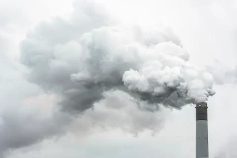 Tall chimney exhausting or pulling a huge quantity of smoke Stock Photos