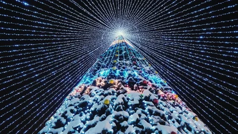 Tall Christmas tree decorated with glowing garlands Stock Footage 144043264