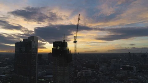 Tall city building under construction revealing dusk sunset, drone aerial 4K Stock Footage 101161114