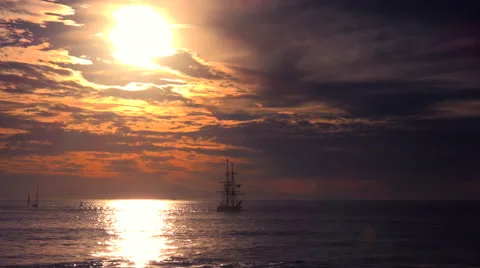 A tall clipper ship sails at sunset. Stockbeeldmateriaal 55512276