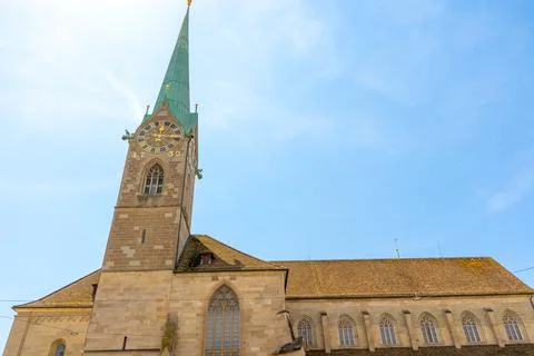 Tall Clock Tower and Spire of Fraumunster Church against Blue Sky in Zurich.. Stock Photos
