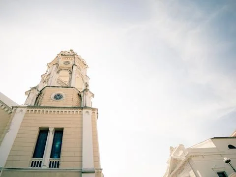 Tall clock tower made of beige stone Stock Photos
