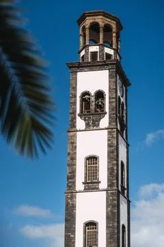 A tall colonial tower with a clock on it Stock Photos