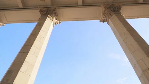 Tall columns on the background of blue sky. Slow motion. Camera in motion Stock Footage 103419480
