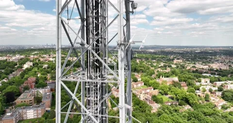 Tall construction of telecommunication tower above residential neighbourhood Vídeos de archivo 201982450