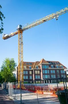 Tall crane at a construction site Stock Photos