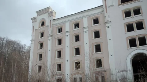 Tall derelict building with many empty window frames, spectral shape can be Stock Footage 320247442