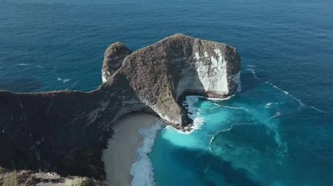The tall elephant cliffs blocking the waves are covered with green trees and  Foto stock