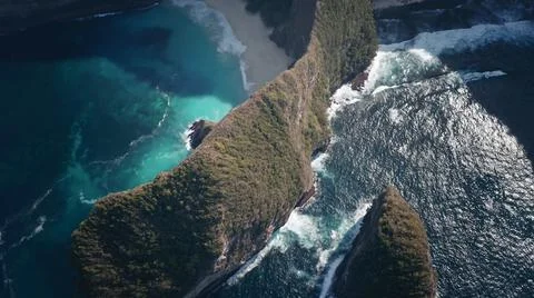 The tall elephant cliffs blocking the waves are covered with green trees and  Foto stock