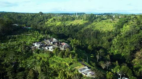 The tall elephant cliffs blocking the waves are covered with green trees and  Stock Photos