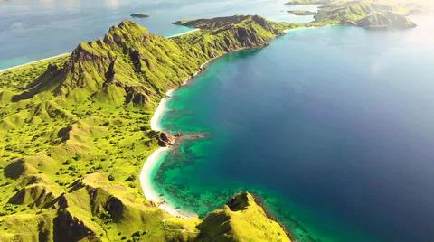 The tall elephant cliffs blocking the waves are covered with green trees and  Foto stock
