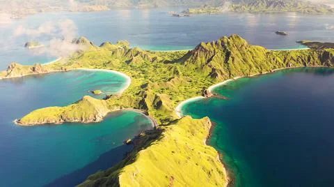 The tall elephant cliffs blocking the waves are covered with green trees and  Stock Photos