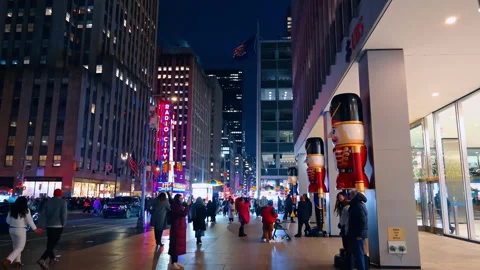Tall figurines of Nutcrackers decorate the building exterior. People walk by the Stock Footage 324752387