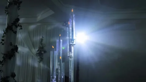 Tall glass candelabras featuring flickering flame electric candles, illuminated Stock Footage 342230917