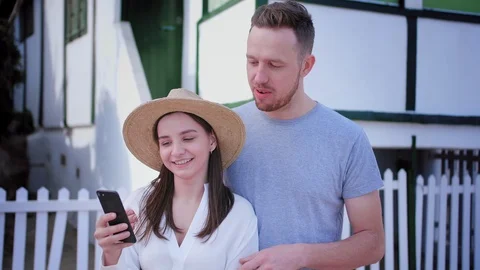 Tall guy accidentally touch straw hat while handsome millennials using internet Stock Footage 107271711
