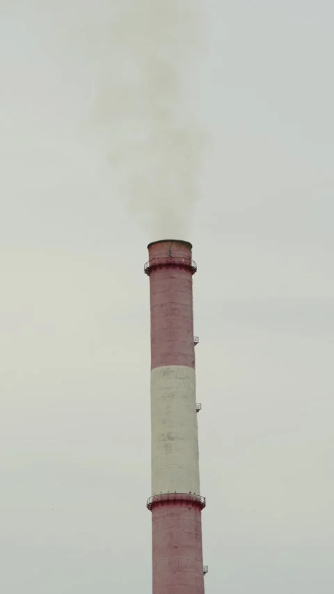 Tall industrial chimney stack emitting smoke at a factory area 库存影片 338198792