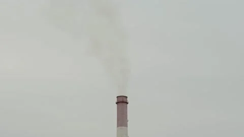 Tall industrial chimney stack emitting smoke at a factory area 库存影片 338201558