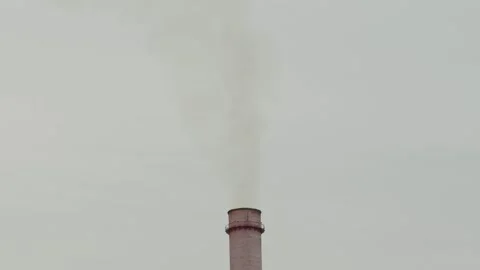 Tall industrial chimney stack emitting smoke at a factory area 库存影片 338201722