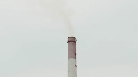 Tall industrial chimney stack emitting smoke at a factory area 库存影片 338201736