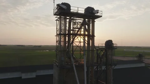 Tall Industrial Fertilizer Elevator Against Rising Sun In Minnesota, USA. drone Stock Footage 314504872