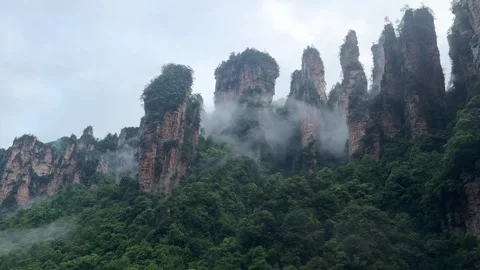 Tall karst Avatar mountain pillars rising above forest valley Video stock 337646776