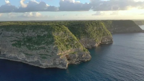 Tall limestone sea cliffs above deep blue water on Grande-Terre in Guadeloupe 動画素材 101568844