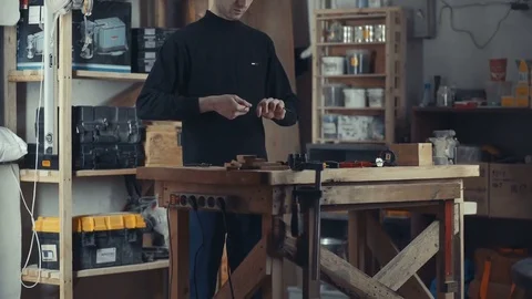 The tall man in the black turtleneck working with wires and electrics Video stock 73012980