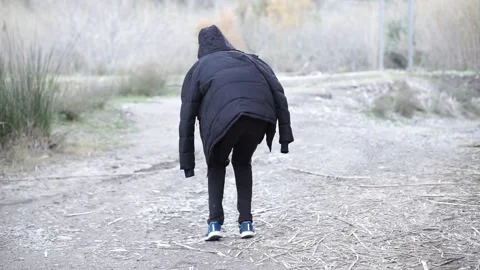 Tall man in a jacket walking like a gnome Stock Footage 149873931