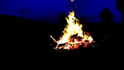 Tall Man Turning Burning Garbage In Large Bonfire on Cottage Backyard Video stock 74979096