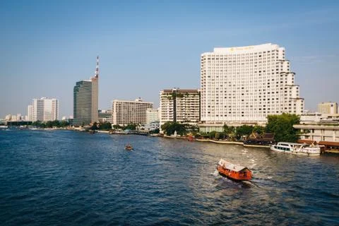 Tall modern buildings along the Chao Phraya River, in Bangkok, Thailand. Stock Photos