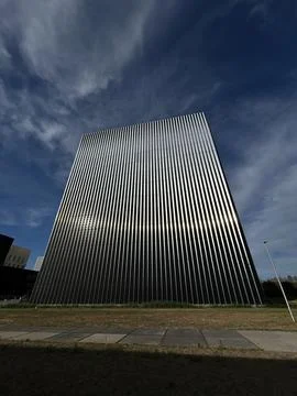 Tall modern office tower viewed from low angle with vertical facade lines Stock Photos