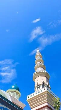 Tall mosque tower with bright sky view Stock Photos