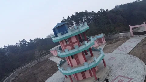 Tall observation tower surrounded by trees on a foggy morning near a rural area Stock Footage 305764808