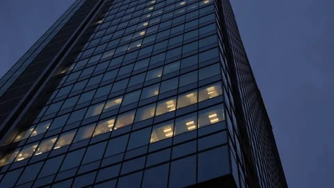 Tall office building facade with some room with light at night 動画素材 344010778