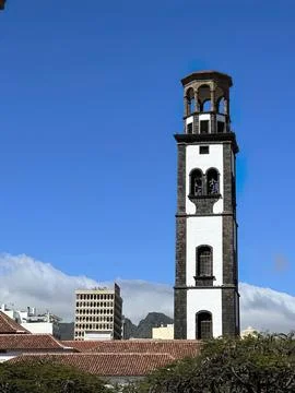 Tall old clock tower with a blue sky background Stock Photos