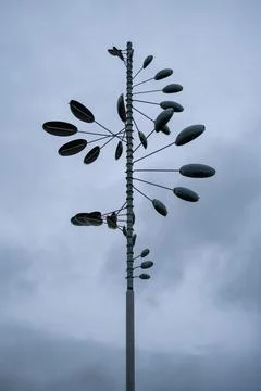 Tall pole holds multiple leaf-shaped wind spinners Stock Photos
