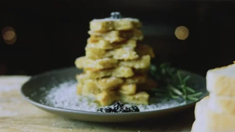 Tall powdered toast stack isolated on a charcoal plate Stock Footage 342128340