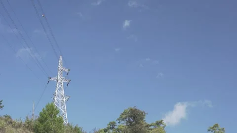A tall power line tower is seen in the distance Stock Footage 313398304